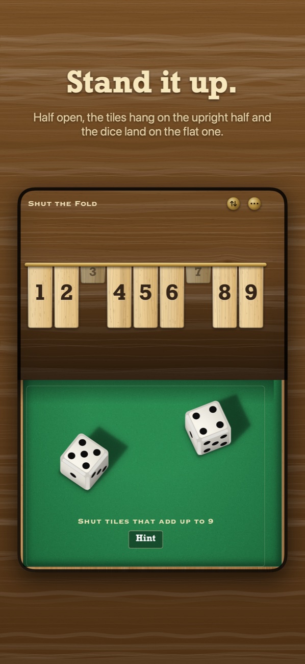 The box stood up on a half-open iPhone Duo: tiles on the upright half, dice on the flat half.