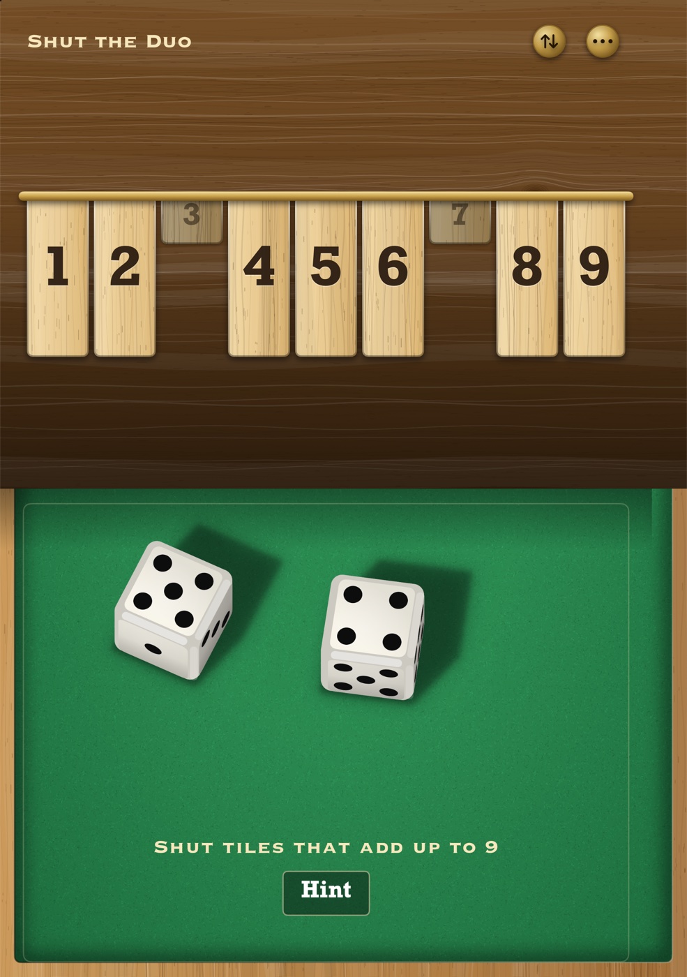 The stood-up box on the inner display: tiles on the upright half, dice on the flat half.